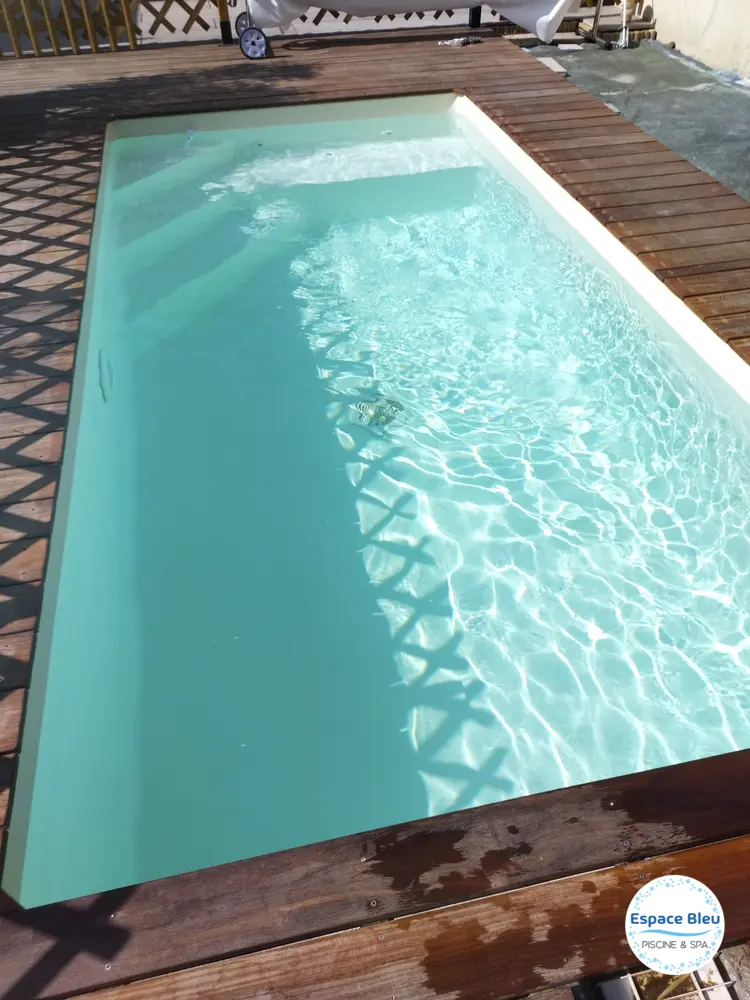 Piscine à eau turquoise sur terrasse bois